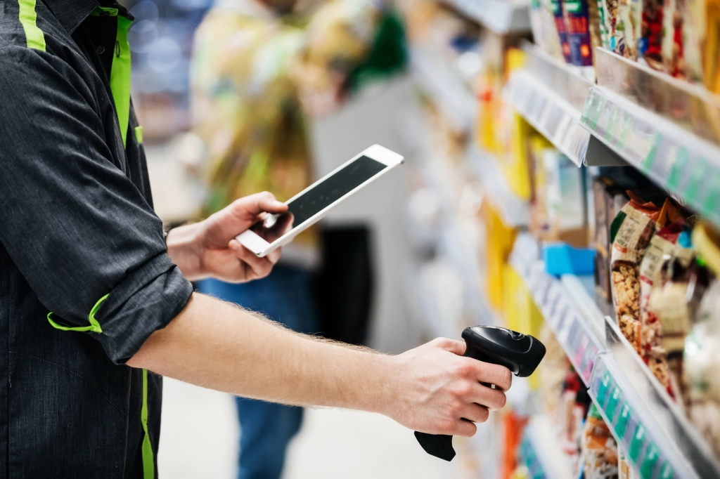 Retail worker checking products with an electric tool, a new trend